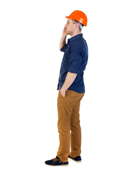 Backview of business man in construction helmet stands and enjoy — Stock Photo, Image