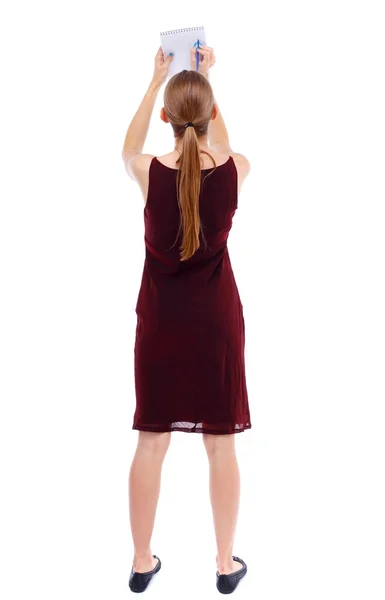 Vista posteriore della donna stand prende appunti in un taccuino — Foto Stock