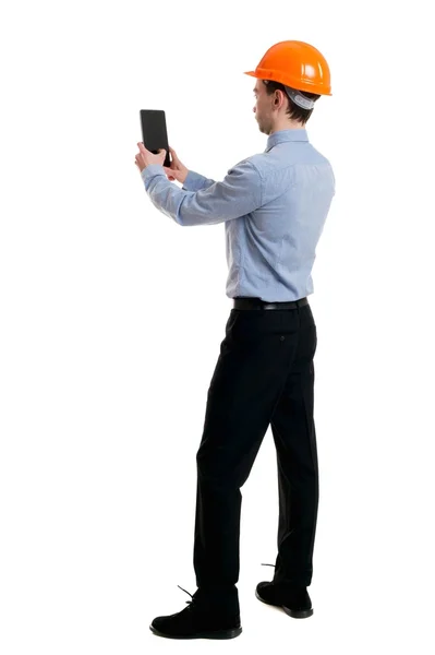 Backview of business man in construction helmet stands and enjoy — Stock Photo, Image