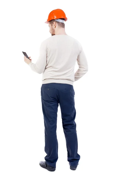 Backview of business man in construction helmet – stockfoto