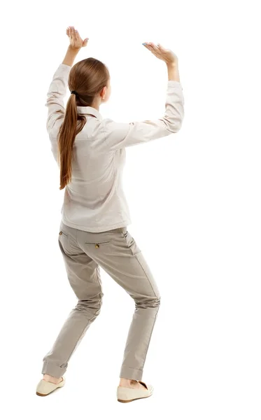 Back view of woman protects hands from what is falling — Stock Photo, Image