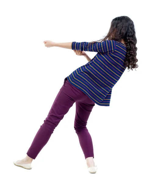 Back view of standing girl pulling a rope from top or cling to s — Stock Photo, Image