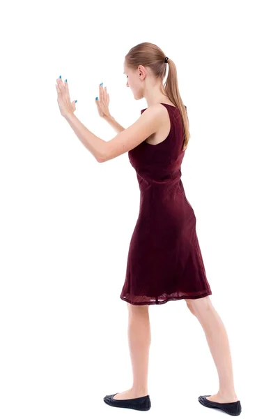 Back view of woman pushes wall. — Stock Photo, Image