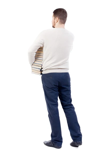 Man carries a heavy pile of books. — Stockfoto