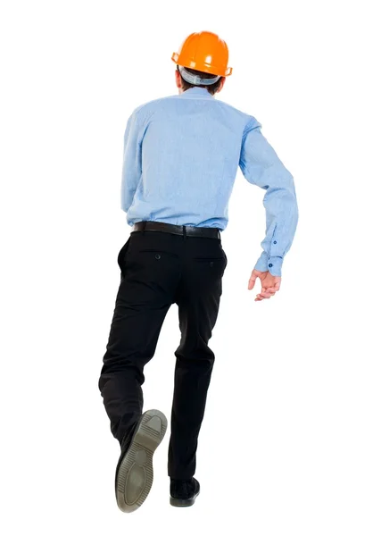 Back view of running engineer in helmet. — Stock Photo, Image