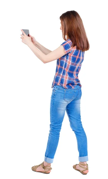 Back view of standing young beautiful  woman  using a mobile pho — kuvapankkivalokuva