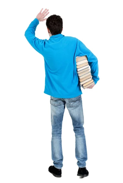 Um homem carrega uma pesado pilha de livros. — Fotografia de Stock