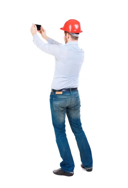 VolverVer de hombre de negocios en el casco de la construcción está parada y disfrutar de — Foto de Stock