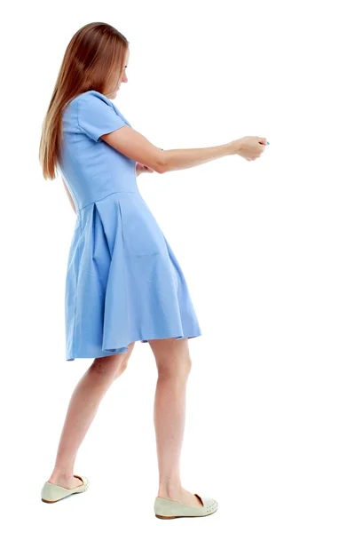 Back view of standing girl pulling a rope from the top or cling — Stock Photo, Image