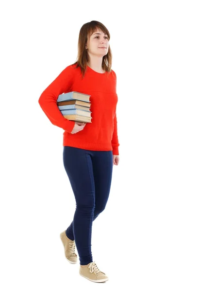 Meisje komt met stapel boeken. — Stockfoto