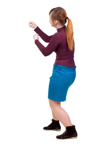 Back view of standing girl pulling a rope from the top or cling — Stock Photo, Image