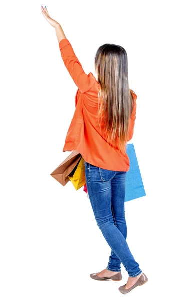 Back view of woman  with shopping bags pointing — Foto Stock