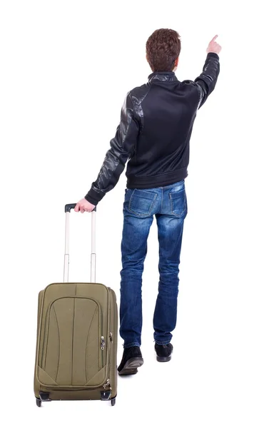 Bakifrån av att peka manen med resväska. — Stockfoto
