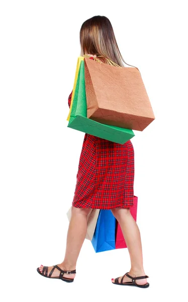 Vista trasera de la mujer que va con bolsas de compras  . — Foto de Stock