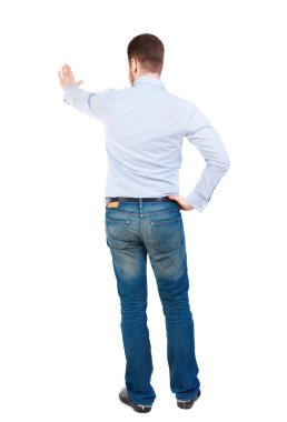 back view of man presses down on something.