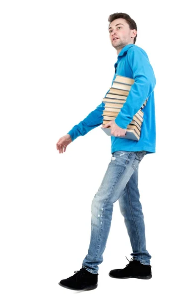 Side view of going  man carries a stack of books. - Stock-foto