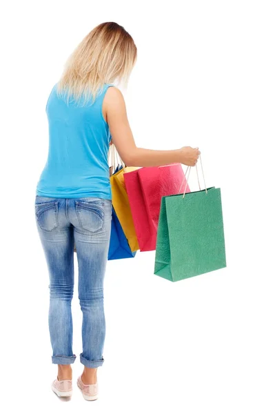 Visão traseira da mulher com sacos de compras — Fotografia de Stock