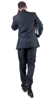back view of walking  business man with books. clipart