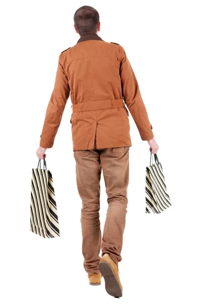 Vista trasera de un hombre guapo con bolsas de compras. — Foto de Stock