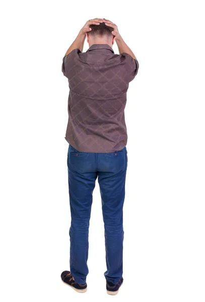 Vista di angry young man in jeans e camicia posteriore. — Foto Stock