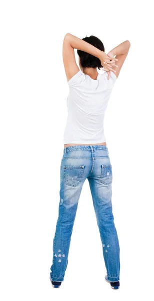 Back view of standing young beautiful  brunette woman in jeans. — Stock Photo, Image