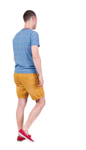 Back view of going  handsome man in shorts.  walking young guy - Stock-foto