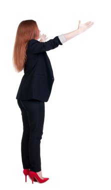 Wal işaret eden genç redhead iş kadını arkadan görünüm