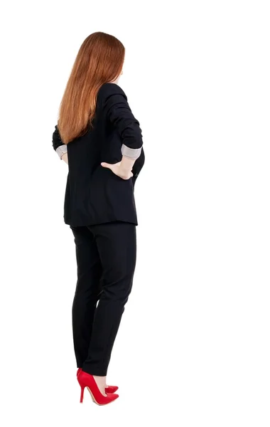 Achteraanzicht van roodharige zakenvrouw overweegt. — Stockfoto