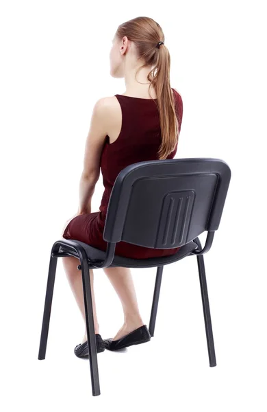 Back view of young beautiful  woman sitting on chair. — Stok Foto