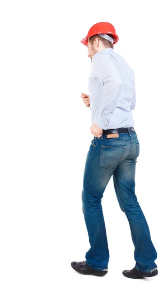 Back view of running engineer in helmet. — Stock Photo, Image