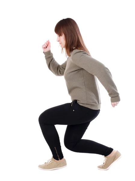 Bakifrån stående ung vacker kvinna i jeans — Stockfoto