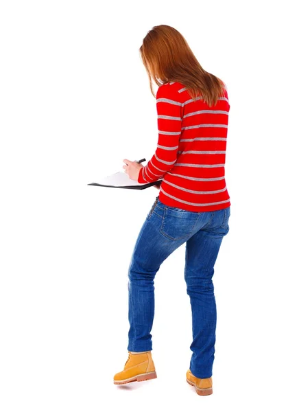 Vista trasera de soportes mujer toma notas en un cuaderno — Foto de Stock