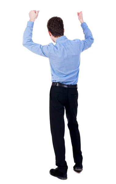 Back view of  man.  Raised his fist up in victory sign. Stock Image