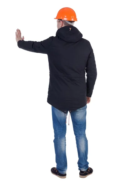 Hintere Ansicht. konstruieren Sie seine Hand in eine Jacke und Helm-Pressen. — Stockfoto