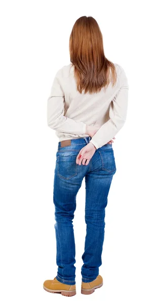 Achteraanzicht van staande jonge mooie vrouw in spijkerbroek. — Stockfoto