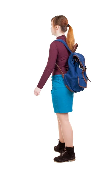 Back view of  woman with backpack looking up. – stockfoto
