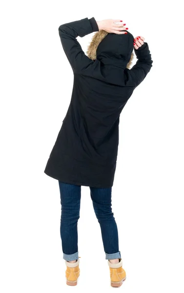 Back view woman in winter jacket  Balances waving his arms. — Stock Photo, Image