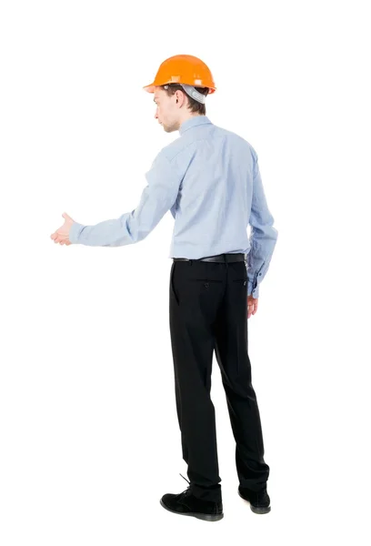 Backview of an engineer in construction helmet stands. — Stock Photo, Image