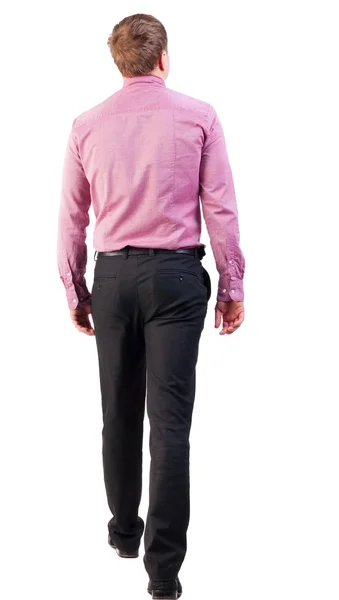 Achteraanzicht van gaan knappe zakenman in roze shirt — Stockfoto