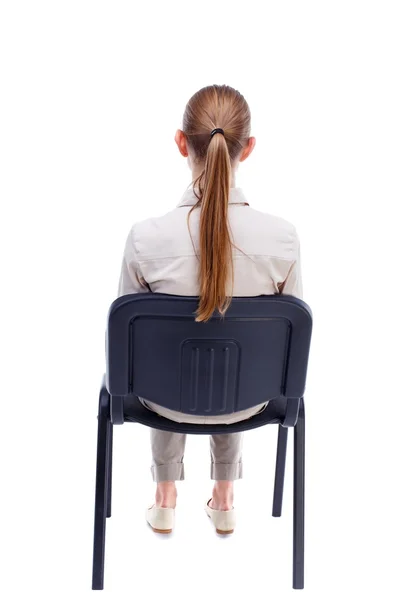Fiatal gyönyörű nő ül a székre hátulnézet. — Stock Fotó