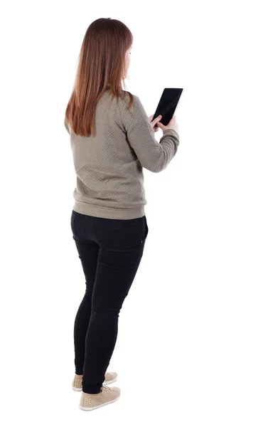 Back view of standing young beautiful  woman  using a mobile pho — Stock Photo, Image