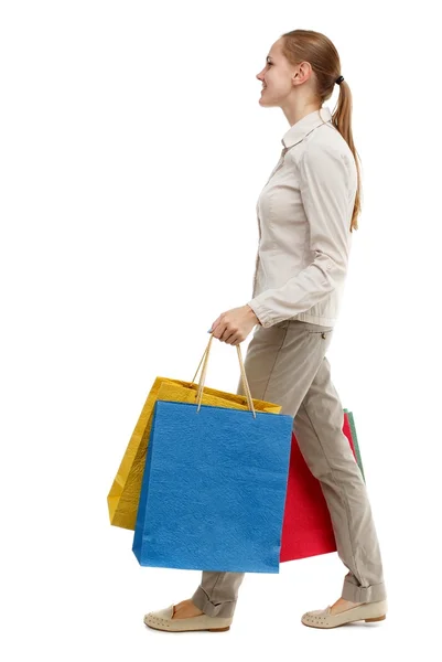 Side view of going  woman  with shopping bags . — Stok fotoğraf