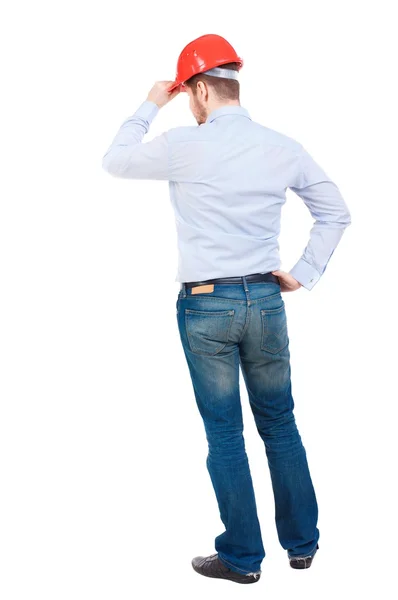 Backview of an engineer in construction helmet stands. — Stock Photo, Image