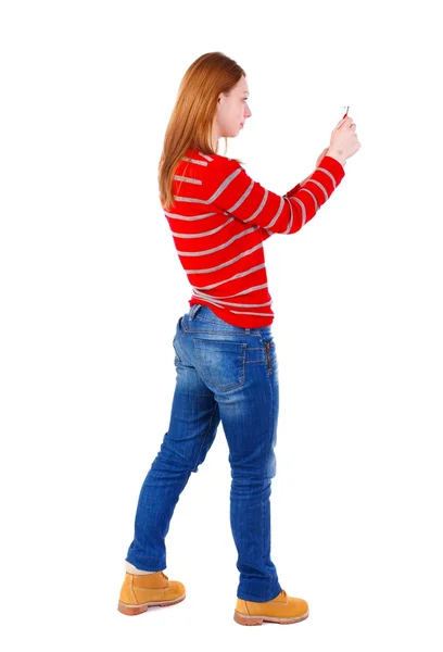 Back view of standing young beautiful  woman  using a mobile pho — Stock Photo, Image