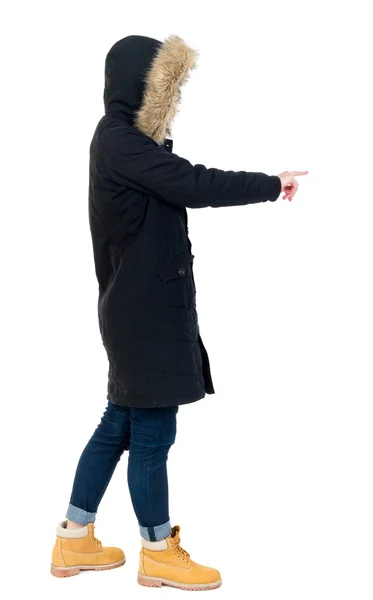 Back view of  pointing young women in parka. — Stock Photo, Image