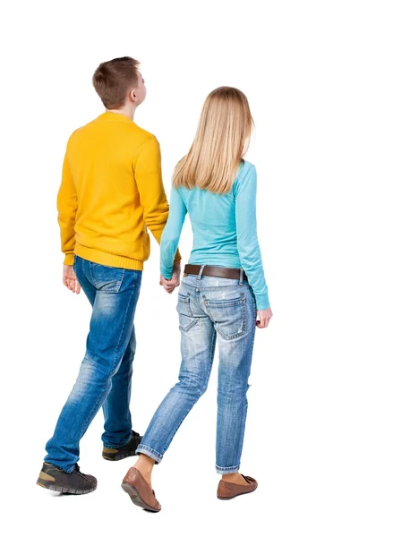 Back view going couple. walking friendly girl and guy holding h — Stock Photo, Image