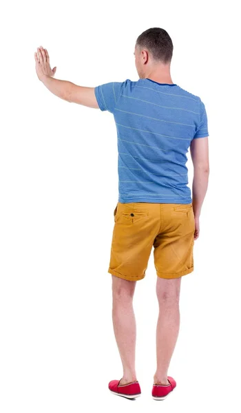 Back view of man. Young  in shorts presses down on something — Φωτογραφία Αρχείου