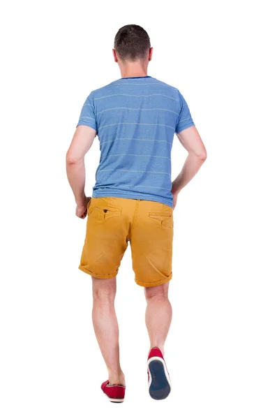 Back view of running man in t-shirt and shorts — Stock Photo, Image