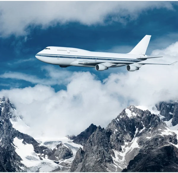 Flugzeug fliegt über die schneebedeckten Berge. — Stockfoto