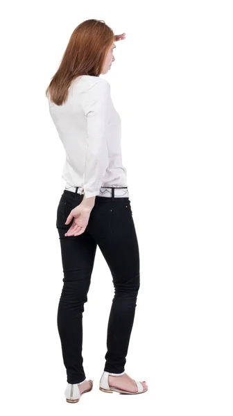 Vista della donna bionda bella giovane in piedi in jeans posteriore. — Foto Stock